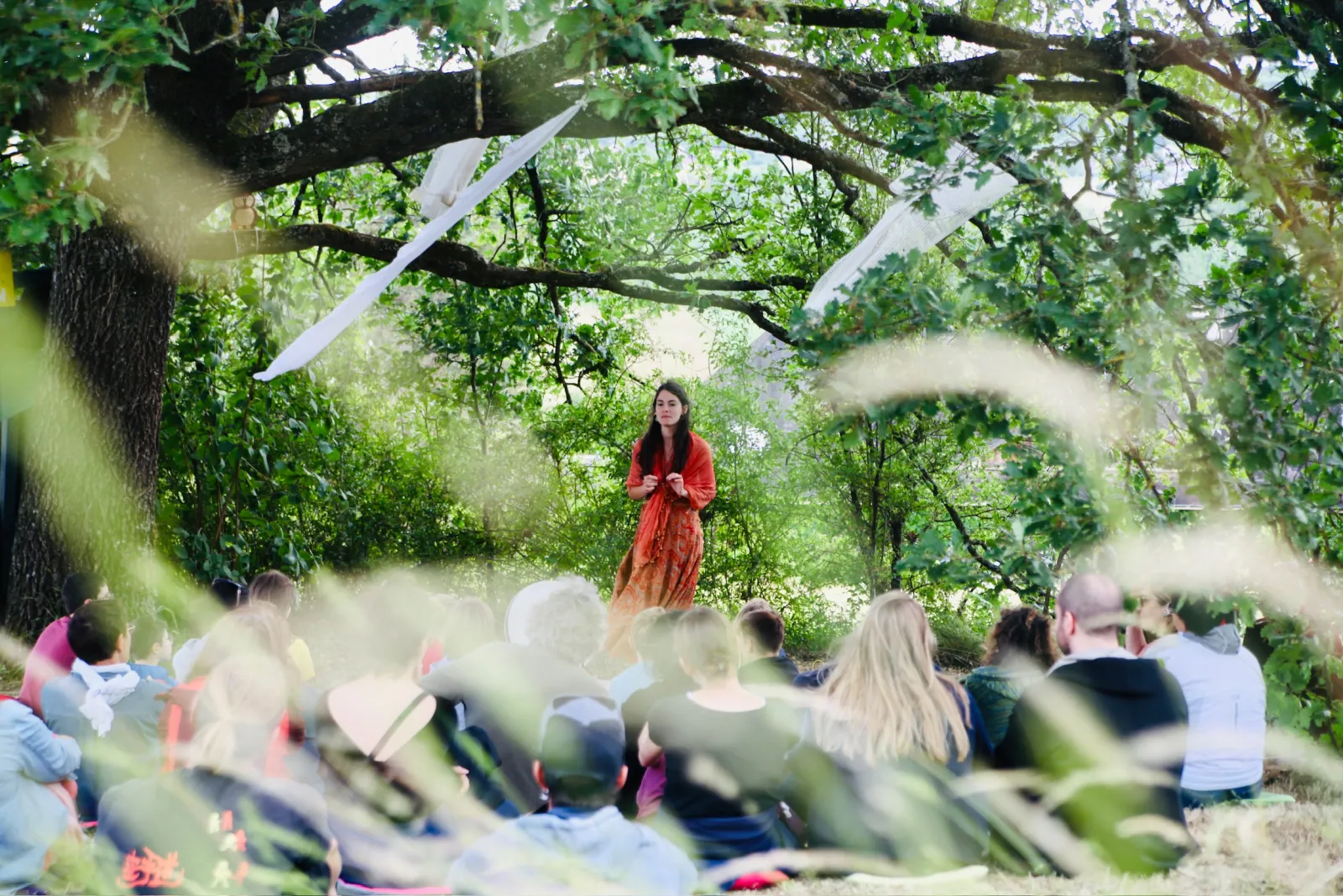 A storyteller under a tree at Foray